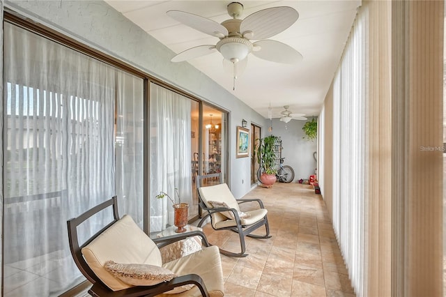 sunroom featuring ceiling fan