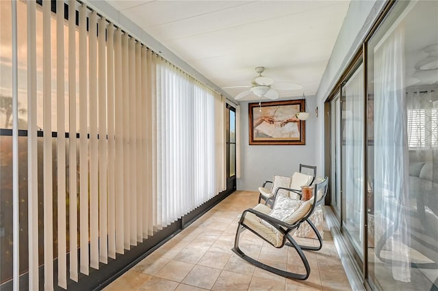 sunroom / solarium featuring a ceiling fan