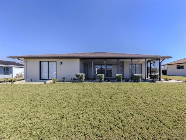 1602 Jim Jim Ct, Venice, FL 34293 - back of house with a yard, stucco siding, and a sunroom