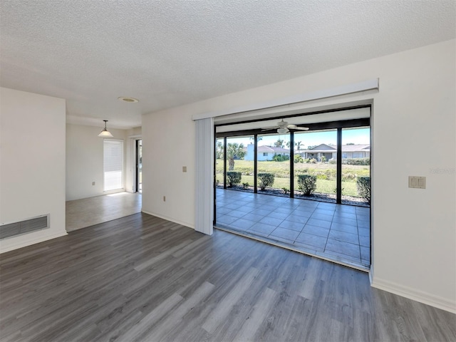 1602 Jim Jim Ct, Venice, FL 34293 - spare room featuring wood finished floors and a textured ceiling