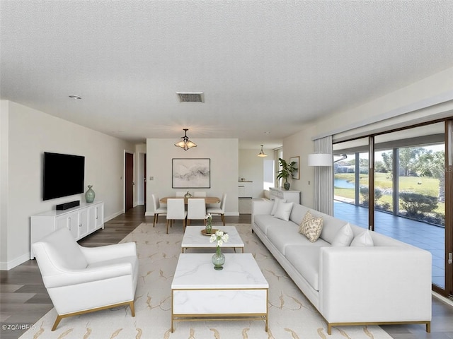 1602 Jim Jim Ct, Venice, FL 34293 - living room with light wood-style flooring and a textured ceiling