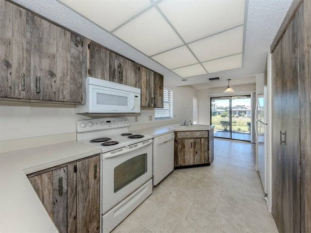 1602 Jim Jim Ct, Venice, FL 34293 - kitchen with white appliances, a peninsula, and light countertops