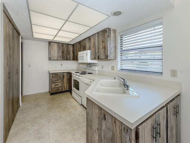 1602 Jim Jim Ct, Venice, FL 34293 - kitchen with white appliances, light countertops, a textured ceiling, and light tile patterned floors