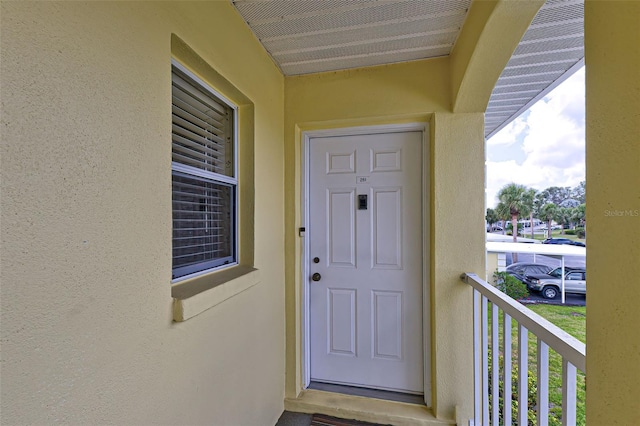 property entrance with stucco siding