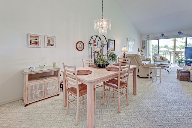 carpeted dining area featuring a notable chandelier and high vaulted ceiling