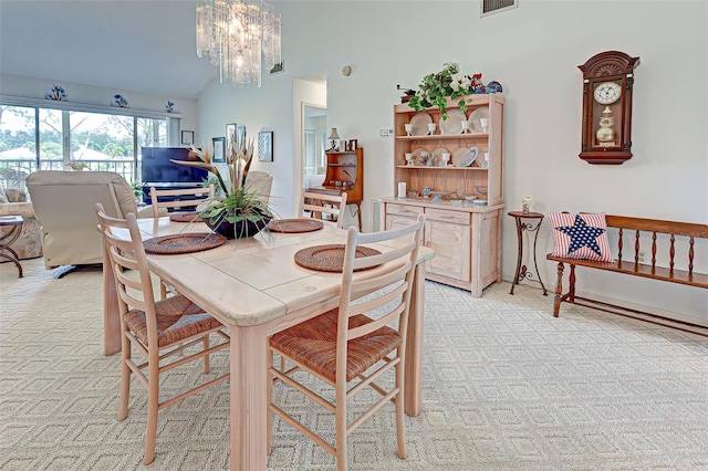 dining room featuring vaulted ceiling, visible vents, and a chandelier