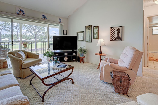 living room with lofted ceiling and baseboards