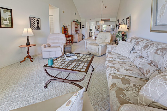 living area featuring baseboards, carpet floors, and vaulted ceiling