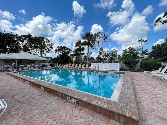 community pool featuring a patio area and fence