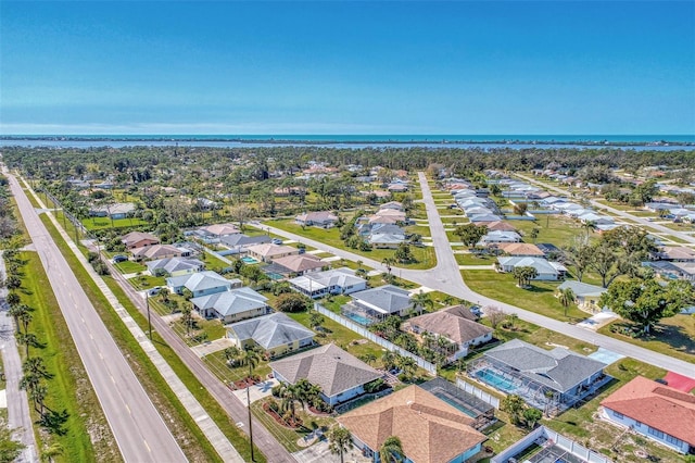 drone / aerial view with a residential view and a water view