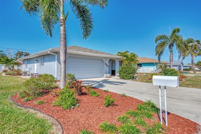 ranch-style house with fence, driveway, central AC, stucco siding, and a garage