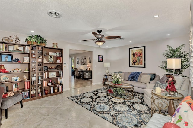 living room with a ceiling fan, baseboards, visible vents, recessed lighting, and a textured ceiling