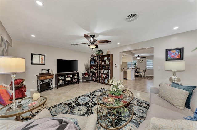 living room with visible vents, baseboards, ceiling fan, light tile patterned floors, and recessed lighting