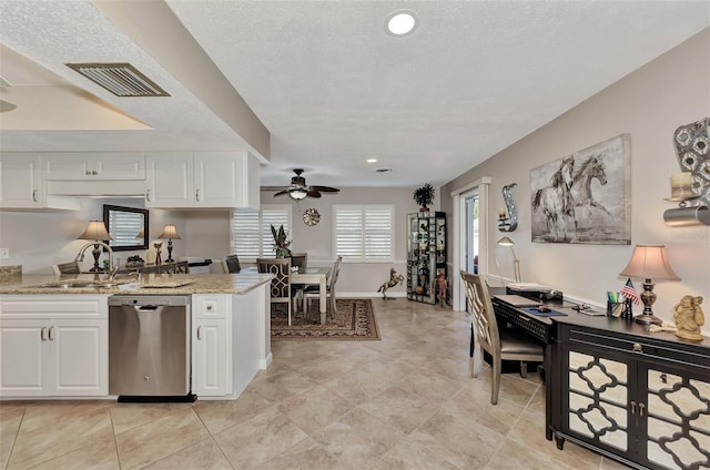 kitchen with visible vents, a ceiling fan, a sink, stainless steel dishwasher, and white cabinets