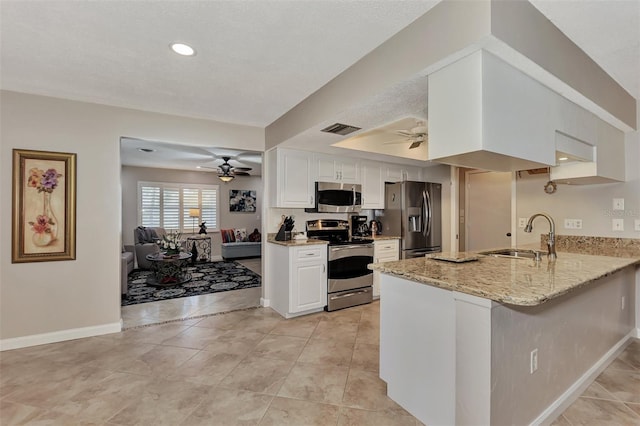 kitchen featuring visible vents, appliances with stainless steel finishes, a ceiling fan, and a sink