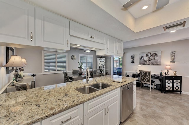 kitchen with stainless steel dishwasher, a ceiling fan, white cabinetry, and a sink