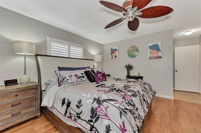 bedroom featuring light wood-type flooring, baseboards, and ceiling fan