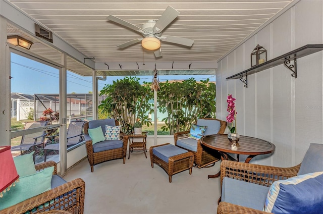 sunroom featuring a ceiling fan