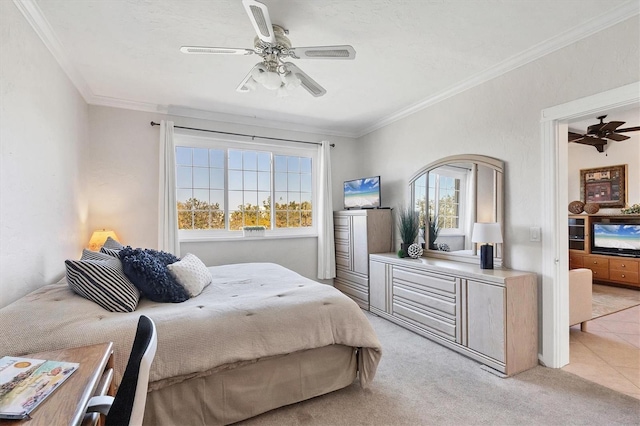 bedroom with ceiling fan, light carpet, and ornamental molding