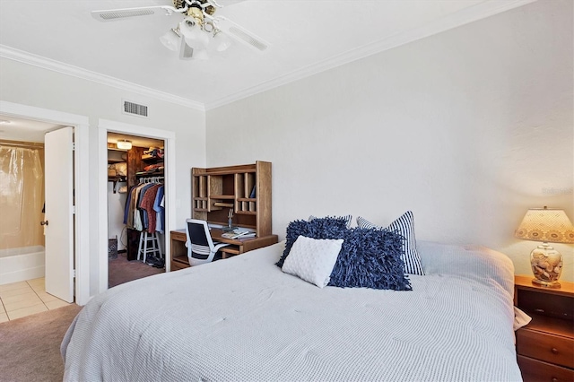 bedroom featuring visible vents, a closet, crown molding, tile patterned flooring, and a spacious closet