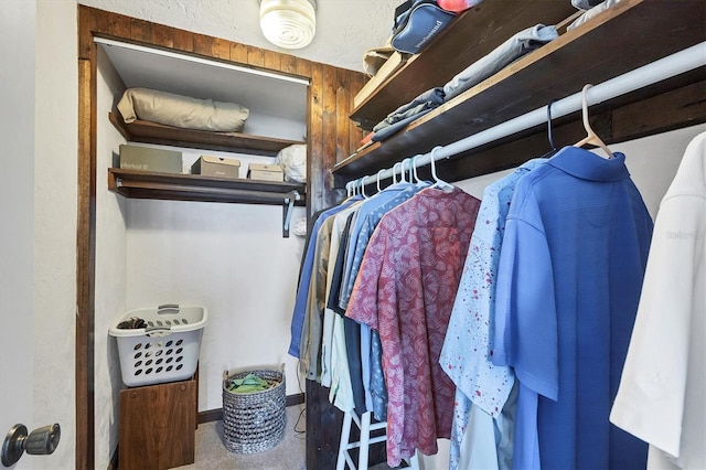 walk in closet with carpet flooring