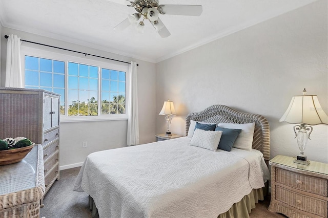 carpeted bedroom with crown molding, baseboards, and ceiling fan