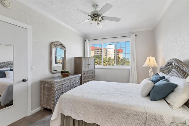 bedroom with carpet, ornamental molding, a ceiling fan, and a textured wall