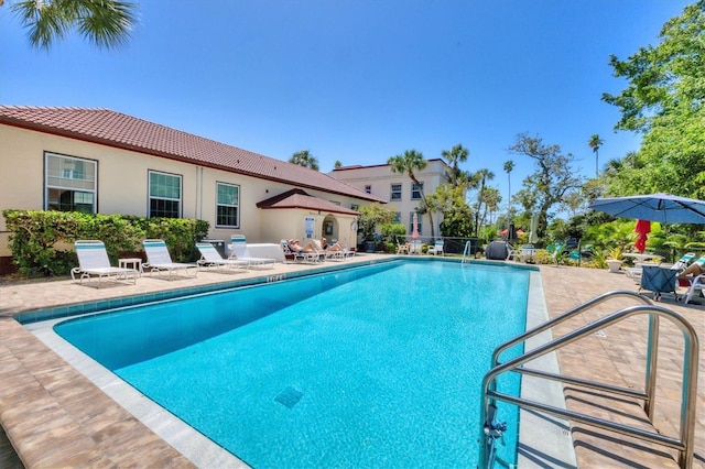 community pool with a patio area