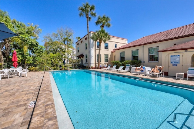 community pool featuring a patio area and fence