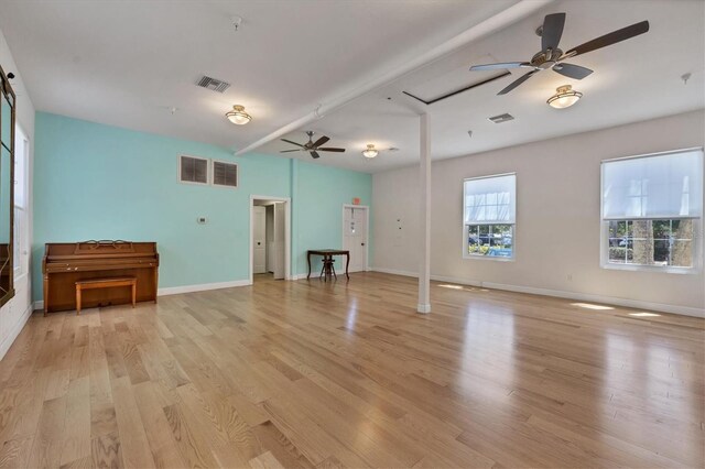 unfurnished living room featuring visible vents, baseboards, light wood-style flooring, and a ceiling fan