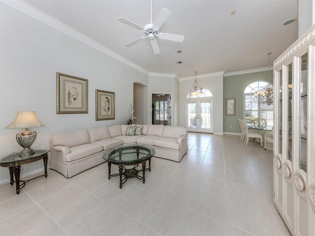 living room featuring arched walkways, plenty of natural light, light tile patterned flooring, and ornamental molding