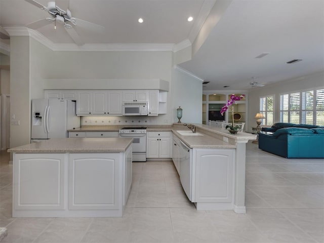 kitchen featuring open floor plan, white appliances, a peninsula, and ceiling fan