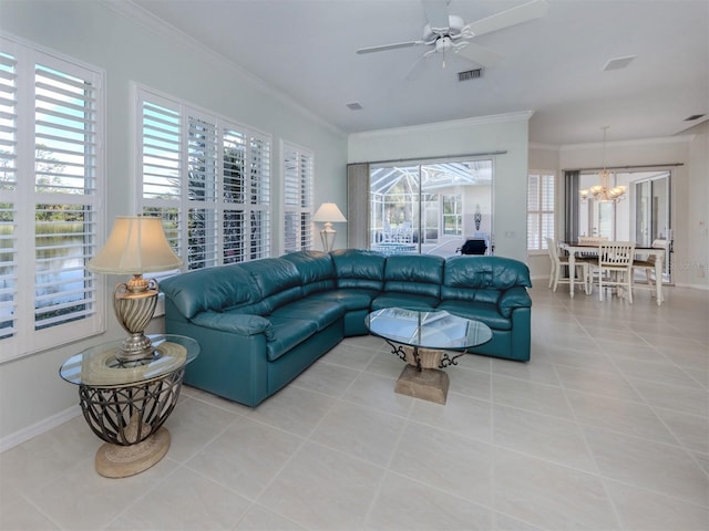 tiled living room with visible vents, ceiling fan with notable chandelier, crown molding, and baseboards