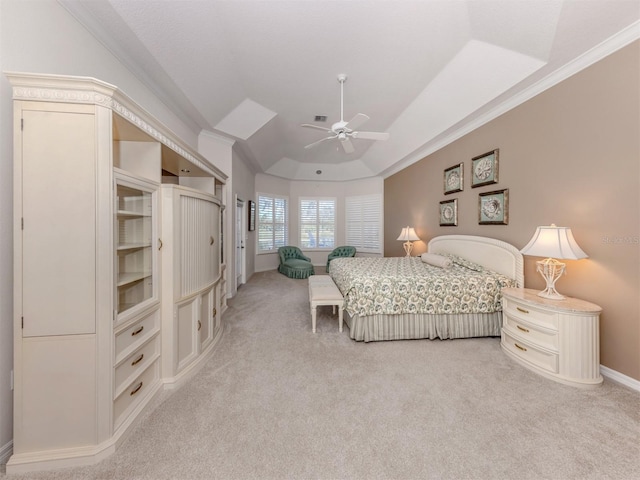 bedroom with a ceiling fan, baseboards, ornamental molding, light carpet, and a raised ceiling