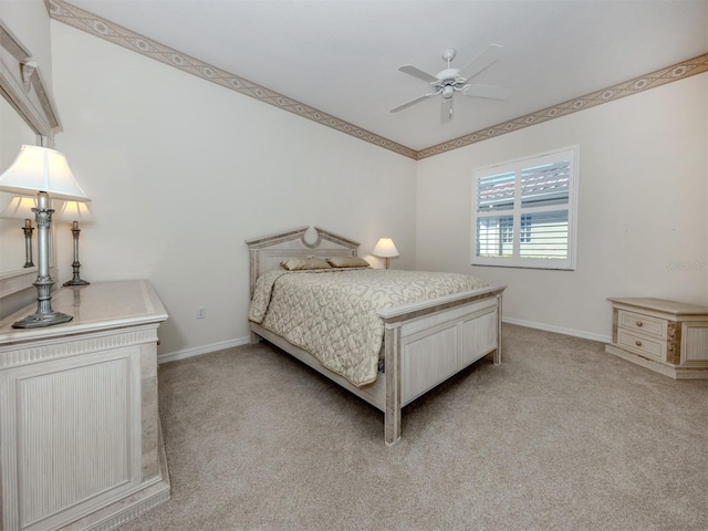 bedroom featuring light colored carpet, baseboards, and ceiling fan