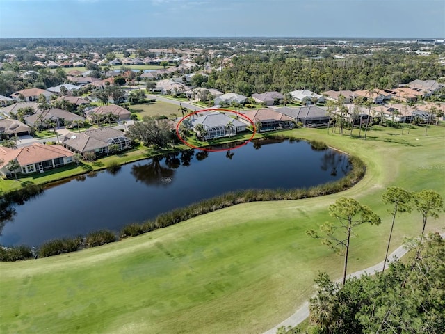 drone / aerial view featuring a residential view, view of golf course, and a water view