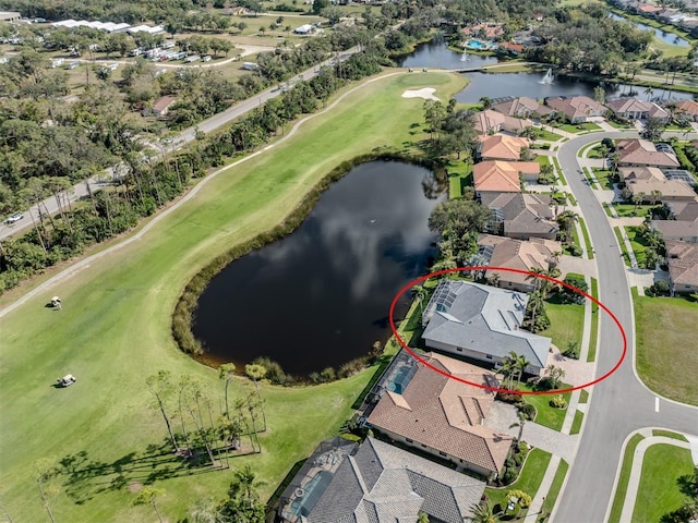 drone / aerial view featuring a residential view, golf course view, and a water view