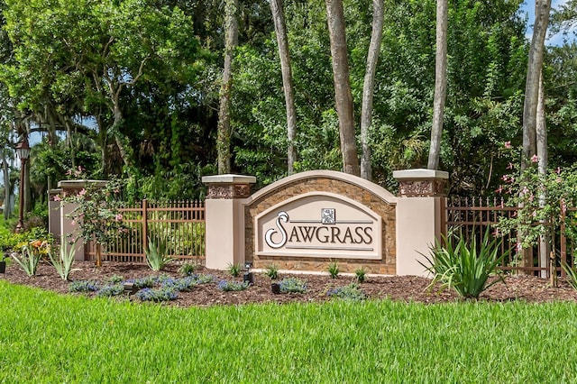 community sign featuring fence