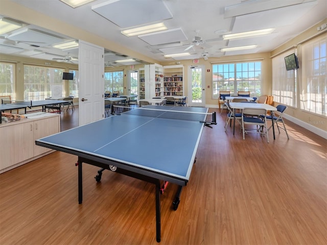 rec room featuring plenty of natural light, ceiling fan, and wood finished floors