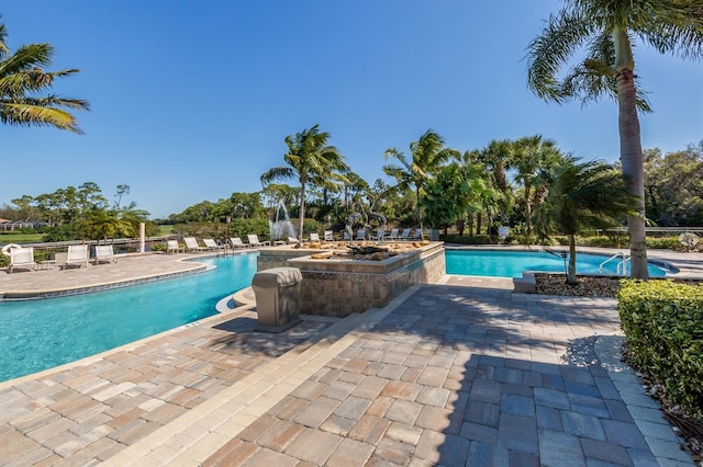 community pool with a patio area