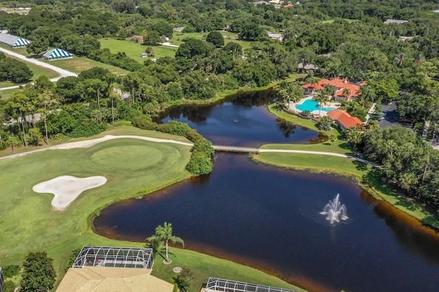 birds eye view of property with a water view, a view of trees, and golf course view