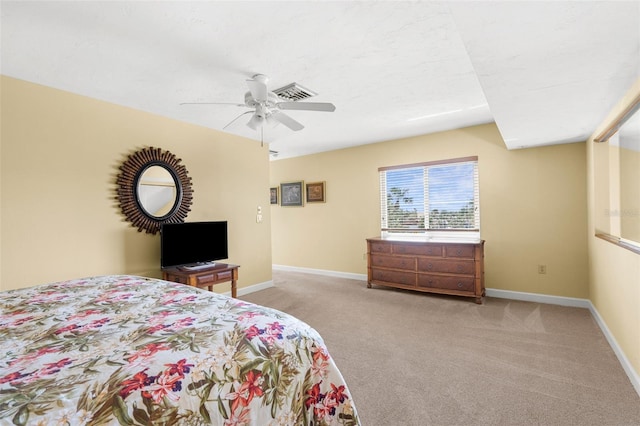 bedroom featuring visible vents, light colored carpet, baseboards, and ceiling fan