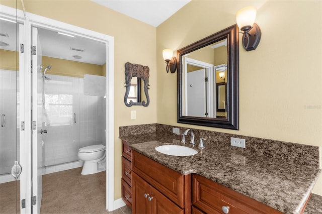 full bath with toilet, a stall shower, vanity, and tile patterned flooring