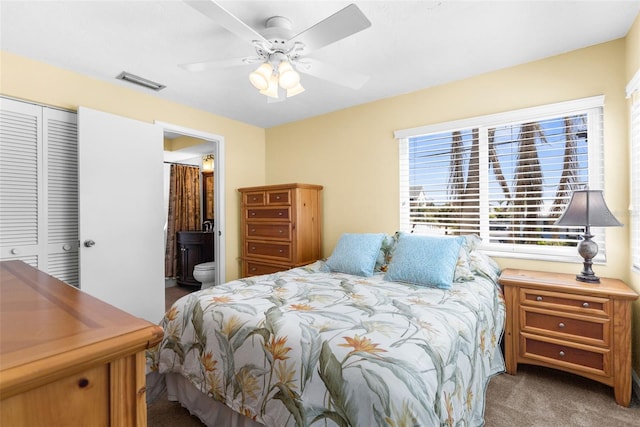 bedroom featuring visible vents, a ceiling fan, ensuite bath, a closet, and carpet flooring