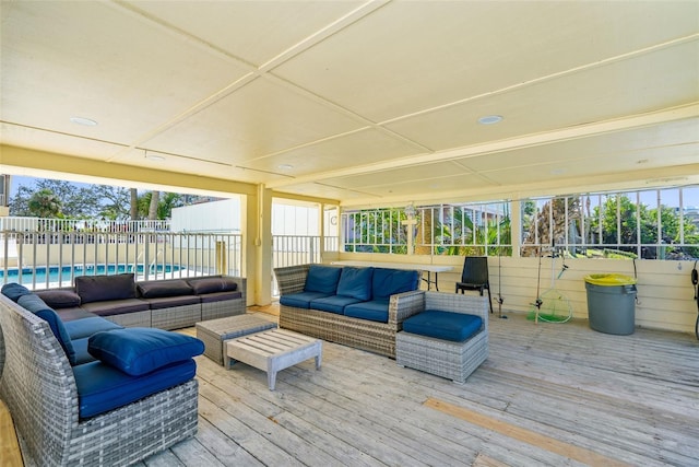 deck with outdoor lounge area, fence, and a fenced in pool