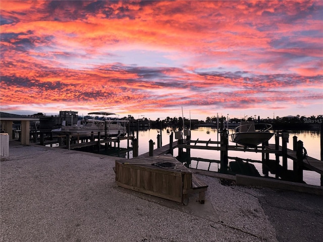 dock area featuring boat lift and a water view