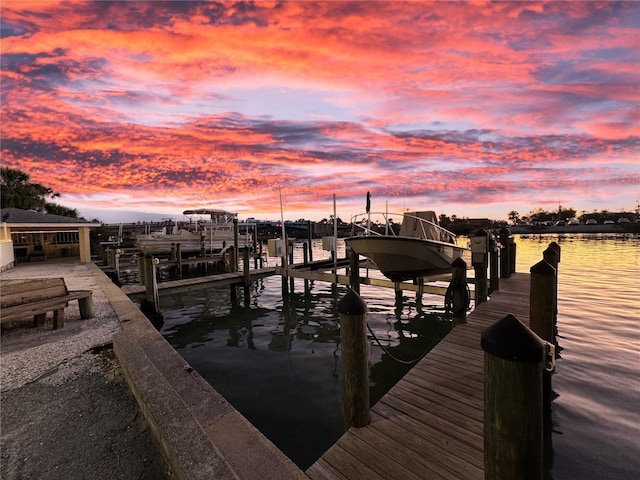 dock area featuring boat lift and a water view