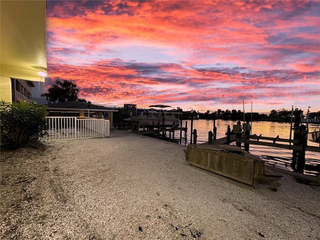 dock area with boat lift and a water view