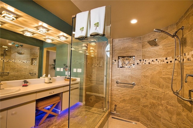 full bath featuring vanity and a tile shower