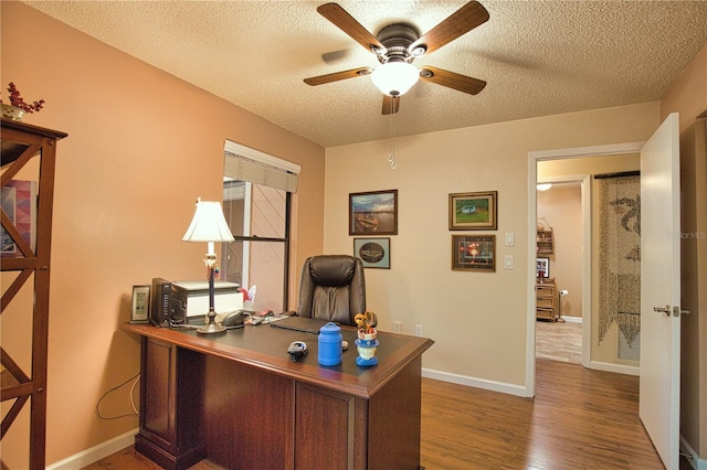 office space featuring a textured ceiling, wood finished floors, baseboards, and ceiling fan